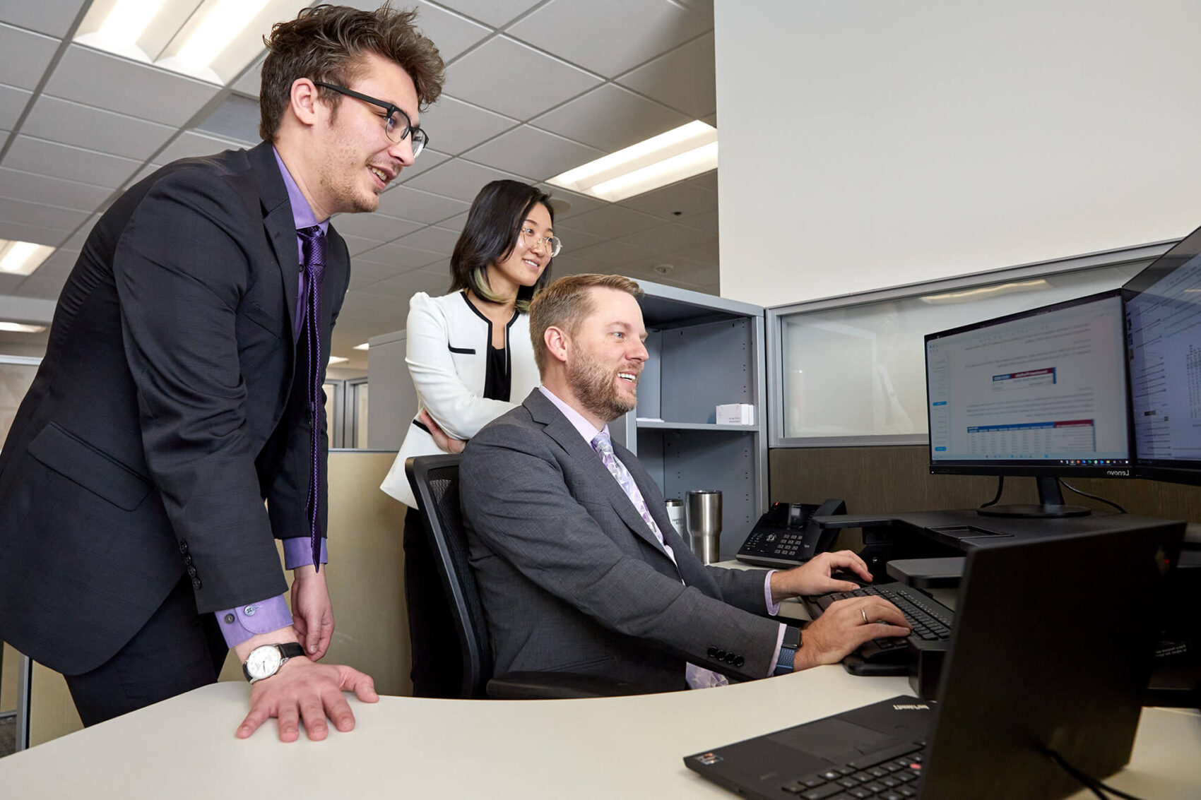 Co-workers looking at a computer screen